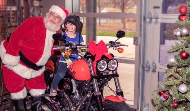 Santa with kid on motorcycle